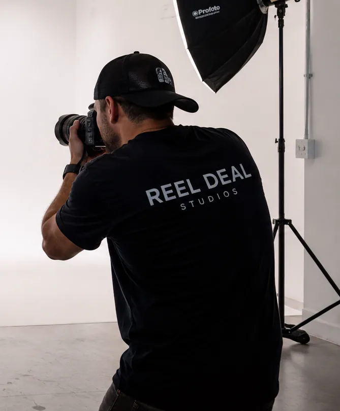 A Reel Deal Studios photographer shooting on the cyclorama in Miami
